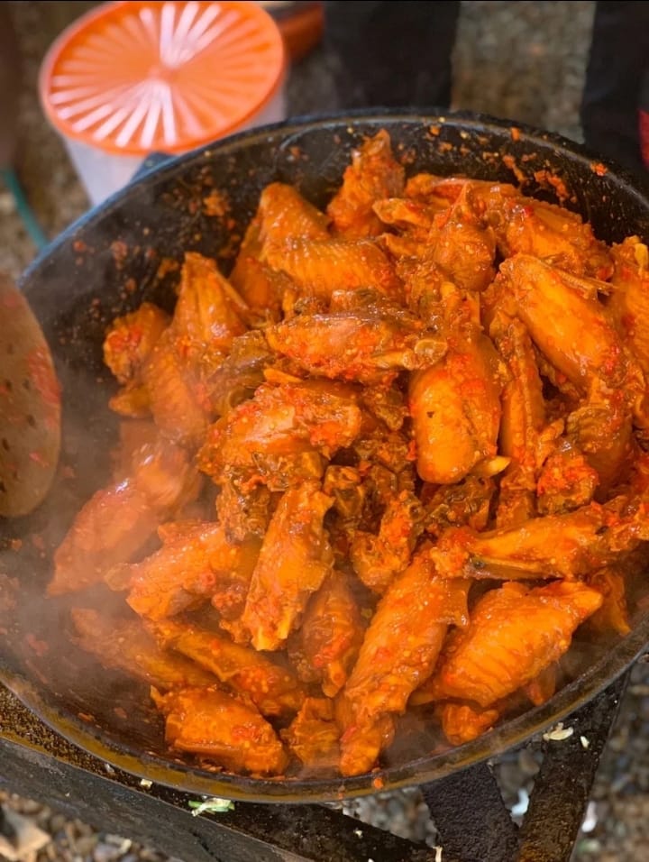 Chicken wings frying in pepper sauce
